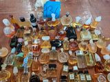 many different types of perfume bottles on the floor