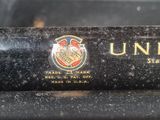 a close up of an old sewing machine with a logo on it