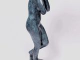a statue of a man holding his head in his hands