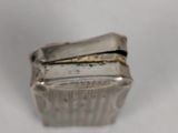 a silver box that is sitting on a white surface