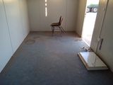 a empty room with a chair and a table in it