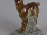 a figurine of a llama standing on a rock