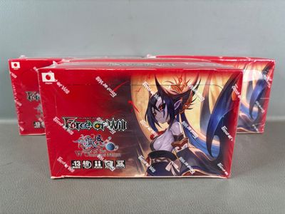 two boxes of card game cards are sitting on a table