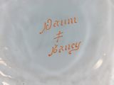a close up of a white plate with orange writing on it