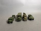 several toy army vehicles are lined up in a row on a table