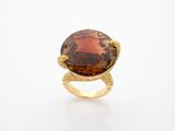 a close up of a ring with a large stone on it