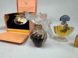 three perfume bottles and a box on a table