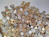 a lot of coins in a white bowl on the table