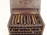 a wooden box with a bunch of cigars inside of it