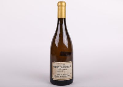 a bottle of wine sitting on top of a white table