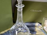 a glass decanter sitting on a table next to a green box