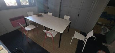 overhead view of a dining room with a table and chairs