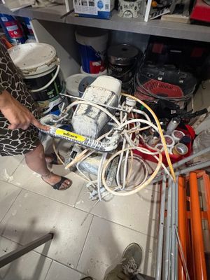 a woman that is working on a machine in a room