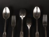 five spoons and a fork on a black table