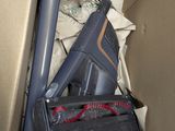 a cardboard box with a gun, gun, and other items in it