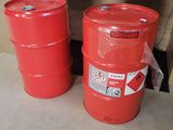 two red barrels sitting next to each other on the floor