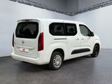 a white van parked in a room with a gray floor