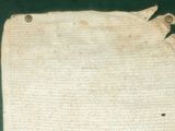 an old piece of paper with writing on it sitting on a table