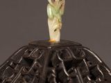 a close up of a decorative object with a flower on it
