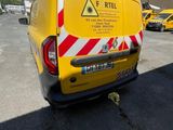 a yellow van that is parked in a parking lot