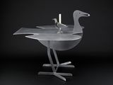 two birds that are sitting on a table