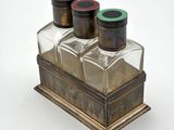 three bottles of salt and pepper shakers sitting on a table