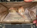 a person holding a piece of paper in a box