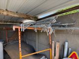a garage with a lot of construction equipment in it