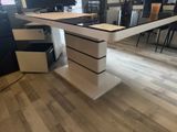 an image of a desk with a computer on top of it