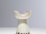 un vase blanc orné d'un motif marron et noir