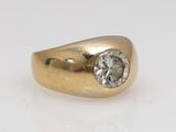 a close up of a gold ring with a diamond on it