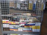 a metal cart with many books on it in a warehouse