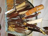 a lot of knives that are in a glass bowl