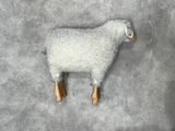 a sheep that is laying down on the floor