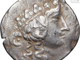 a silver coin with a head of a woman on it