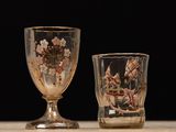 two glasses that are sitting next to each other on a table