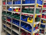 many bins and boxes on the shelves in the warehouse