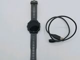 a watch and a charger sitting on a table