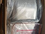 a cardboard box with a bag of bubble wrap in it
