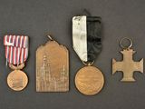three medals and a medal on a table with a black background