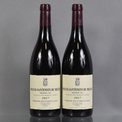 two bottles of wine sitting on top of a table next to each other