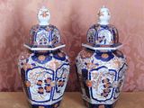 two blue and white vases sitting on a table