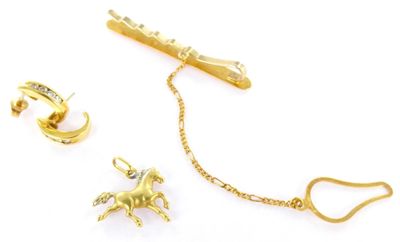 three pieces of jewelry that include a horse on a chain