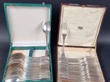 a lot of silver spoons and spoons in a case