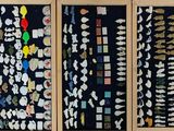 four rows of magnets on the wall of a room
