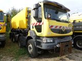 two yellow trucks parked next to each other in a field
