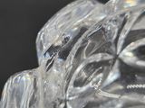 a glass figurine of a man with a hat on
