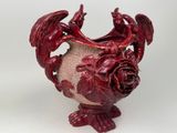 a red vase with a dragon on it on a white background