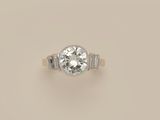 a diamond single - stone ring with baguets