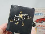 a person holding a black label in their hand